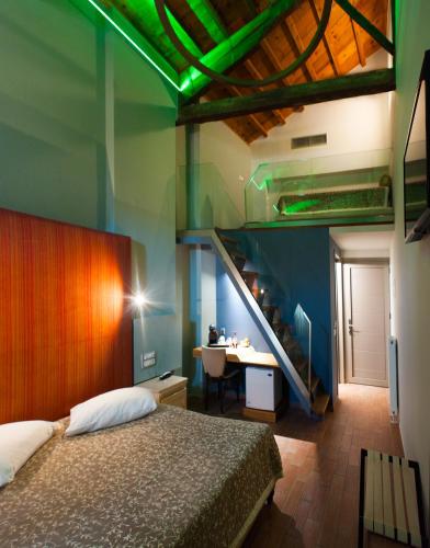 a bedroom with a bed and a staircase with green lights at Splanzia Boutique Hotel in Chania