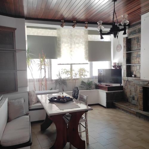 a living room with a table and a couch at Johnny's loft in Agrinion