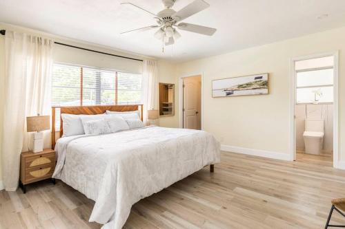 a white bedroom with a bed and a ceiling fan at Spacious 4 Bedroom 3 Bathroom House with Heated Pool and Outdoor Shower close to FFL Airport and Cruise Port in Plantation