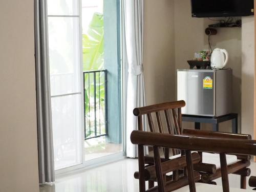an open door to a balcony with a refrigerator at บ้านชมเขา - Baan Chom Khao in Pak Chong
