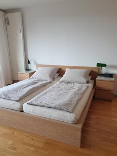 a bedroom with two beds and a night stand at Apartment B311 mit Pool in Lahnstein