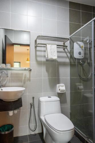 a bathroom with a toilet and a sink at Villa Renai Resort in Bentong