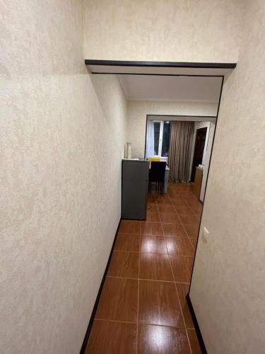 an empty room with a hallway with a table at HASI hotel Jermuk in Jermuk