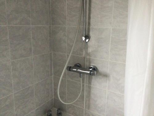 a shower with a shower head in a bathroom at Cool and cosy in Brandon