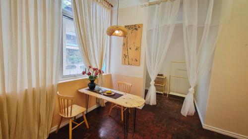 a small dining room with a table and a window at DAISY'S STAY in Hanoi