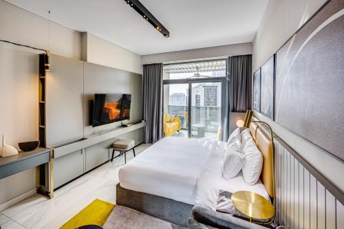 een hotelkamer met een bed en een televisie bij Stylish canal view apartment in Business Bay in Dubai