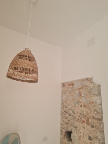 a light hanging from a wall next to a stone wall at Don Ciccio GH in Bova Marina