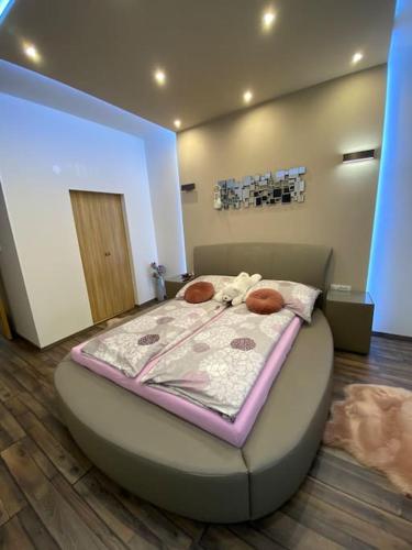 a bedroom with a circular bed with a purple blanket at Robert's Apartment in Celje