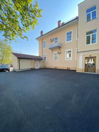 a large parking lot in front of a house at Robert's Apartment in Celje