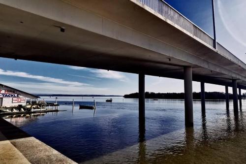 a bridge over a body of water with boats at Waterview luxury hideaway, 2 min walk to all, pool in The Entrance