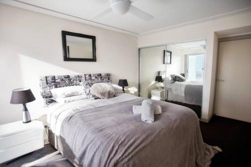 a bedroom with a bed with a teddy bear on it at Waterview luxury hideaway, 2 min walk to all, pool in The Entrance