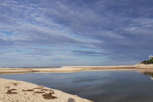 a large body of water on a sandy beach at Waterview luxury hideaway, 2 min walk to all, pool in The Entrance
