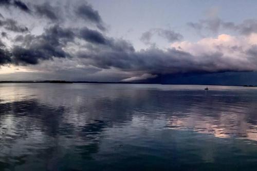a view of a large body of water with a cloudy sky at Waterview luxury hideaway, 2 min walk to all, pool in The Entrance