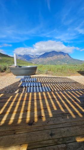 a boat sitting on top of a wooden deck at Little Acre Luxury Pods in Tulbagh