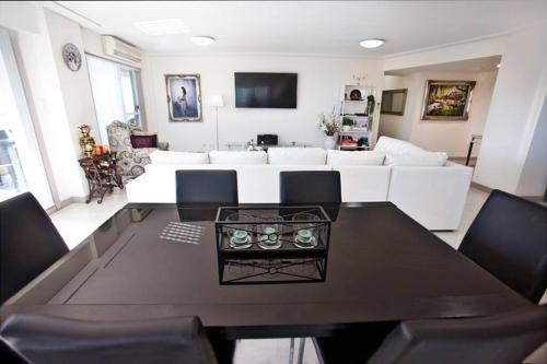 a living room with a table and a white couch at Waterview luxury hideaway, 2 min walk to all, pool in The Entrance