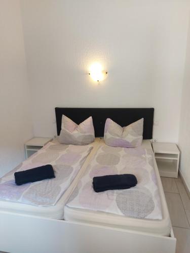 a large white bed with two pillows on it at Apartament central V&P in Sibiu