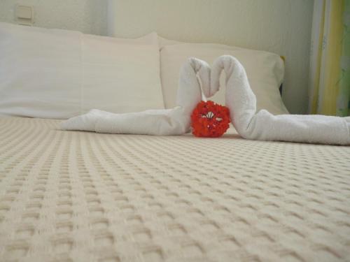 a bed with two swans made out of towels at Galini Hellenic Hospitality in Patitiri
