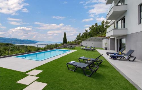 a backyard with a swimming pool and grass at Villa Amata in Mošćenička Draga
