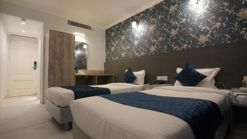 a hotel room with two beds with blue and white at The Shanti A Boutique Hotel in Jodhpur