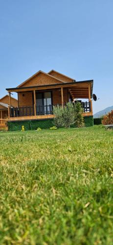 a house sitting on top of a lush green field at 101 Gün Kiralık Lake House Kayacık in Dalaman