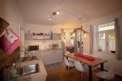 a kitchen with a table and chairs and a dining room at Traditional Apartments Salzburg in Salzburg