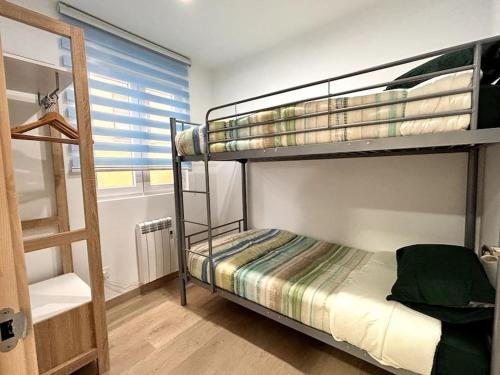 Ένα ή περισσότερα κρεβάτια σε δωμάτιο στο LUJO 10 pax Proyector, Maquina Arcade y Patinetes