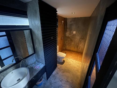 a bathroom with a sink and a toilet at Islanda Hotel Patong in Patong Beach