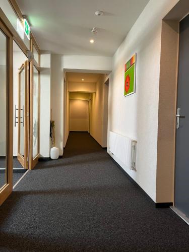 an empty hallway in an office building with a hallway at Hotel de ville d'Yvonand in Yvonand