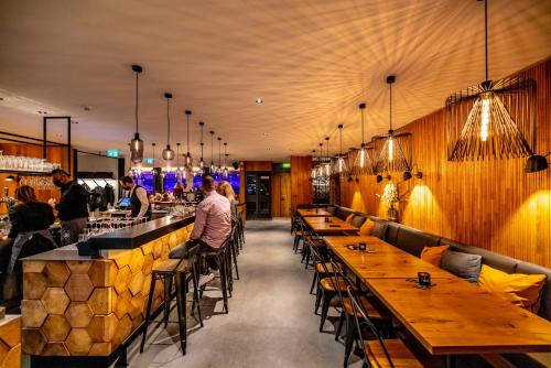 a restaurant with wooden tables and chairs and a bar at Boutique Hotel Pellas in Vella