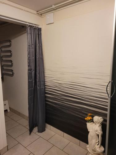 a shower curtain in a bathroom with a view of the water at Karlstorp 4 km från Vimmerby in Vimmerby