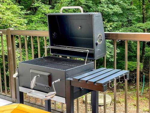 a barbecue grill with a bench next to a fence at Villa Verde 那須 in Nasu