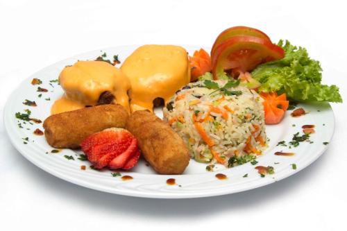 a white plate of food with rice and vegetables at Bristol Exceler Campo Grande in Campo Grande