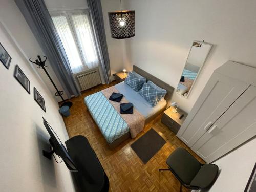a bedroom with a blue bed and a mirror at Eva Capital Guest House in Modena