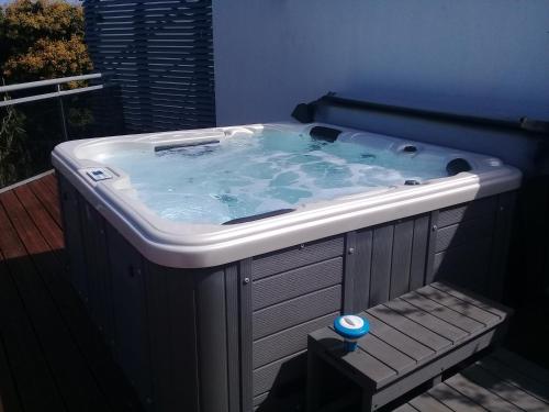 a jacuzzi tub in the corner of a room at AU MEUBLE DURANTAS in Petite Île