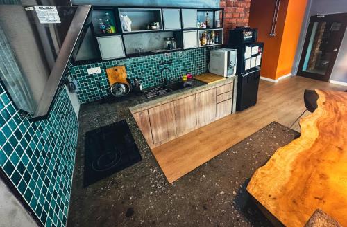 an aerial view of a kitchen with a counter top at Arch Dormitorio Cenang in Pantai Cenang