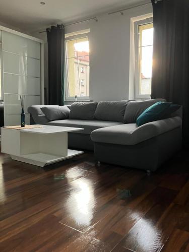 a living room with a couch and a coffee table at Apartament Centrum in Wałbrzych