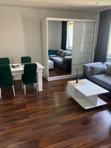 a living room with a couch and a table at Apartament Centrum in Wałbrzych