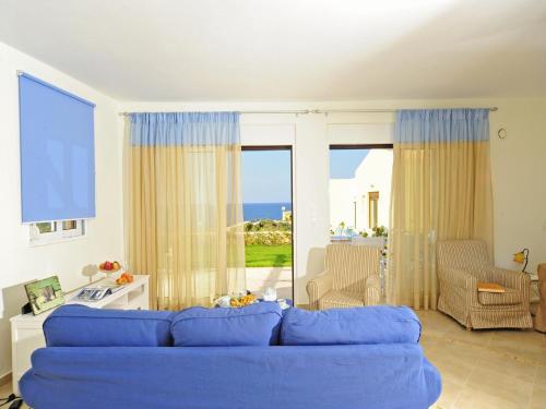 a blue couch in a living room with a view of the ocean at Villa Avra in Panormos Rethymno