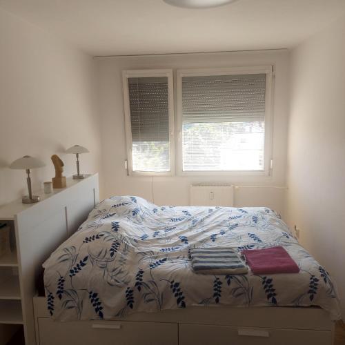 a bedroom with a bed with a blue and white comforter at Byt, Vlasákova 2759, Mělník in Mělník