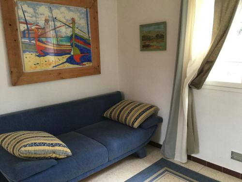 a blue couch in a room with a painting at Villa Delphina in Vernet-les-Bains
