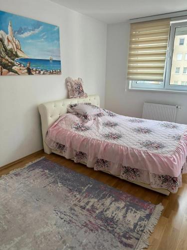 a bedroom with a bed with a pink bedspread at Luxury apartments - Otoka Sarajevo in Sarajevo