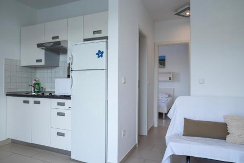 a kitchen with a white refrigerator in a room at VDL Apartments in Trogir