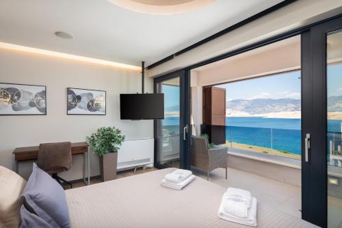 a bedroom with a bed and a view of the ocean at Villa Emma Pag in Pag