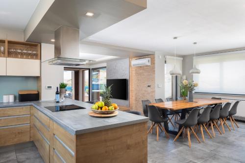 a kitchen with a table with a bowl of fruit on it at Villa Emma Pag in Pag