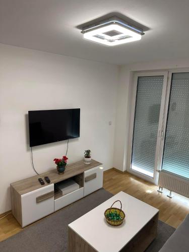 a living room with a flat screen tv on a wall at Sarajevo Otoka - Stan na dan in Sarajevo