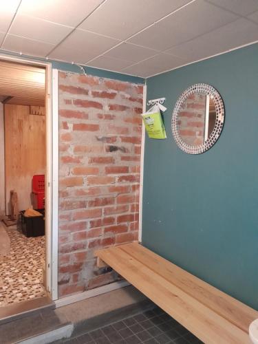 a room with a brick wall and a window at Ugglebo, stuga, mökki, cottage in Nauvo