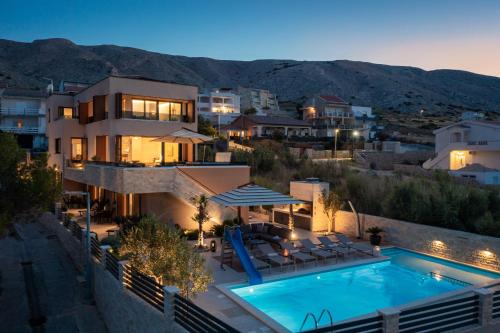 a villa with a swimming pool at night at Villa Emma Pag in Pag
