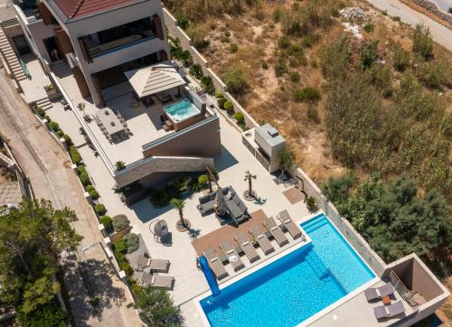 an aerial view of a house with a swimming pool at Villa Emma Pag in Pag
