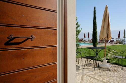 a door to a patio with a table and umbrella at Casa Vacanze Vecciano in Montefalco