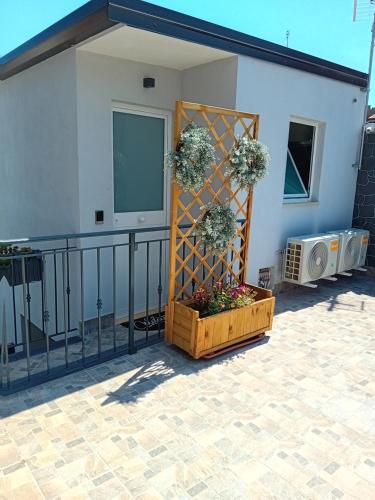 a patio with a fence and flowers in a wooden crate at Al Punto Giusto in Catania